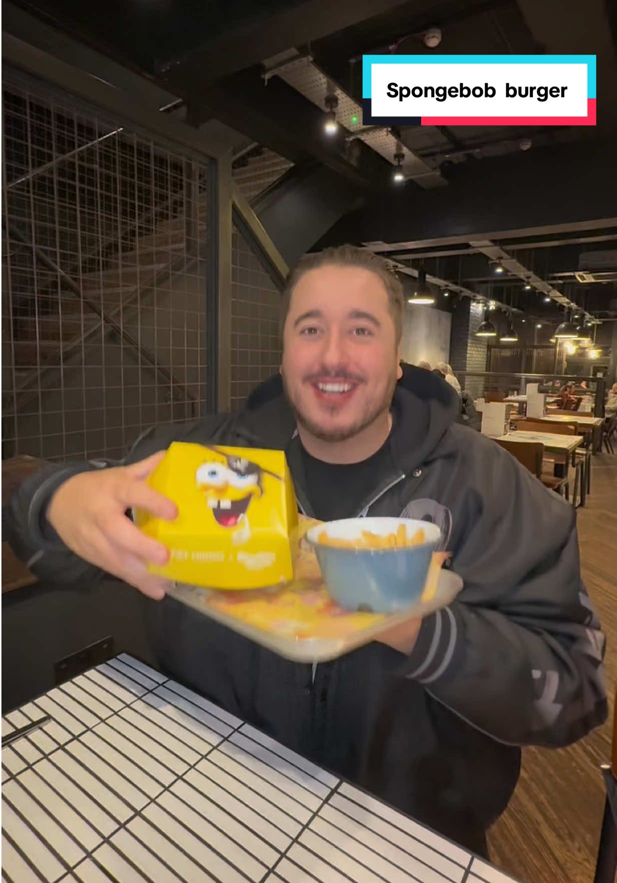 TikTok post by @corysworldd for SpongeBob SquarePants. Caption reads: Trying the @SpongeBob burger from @Fat Hippo....