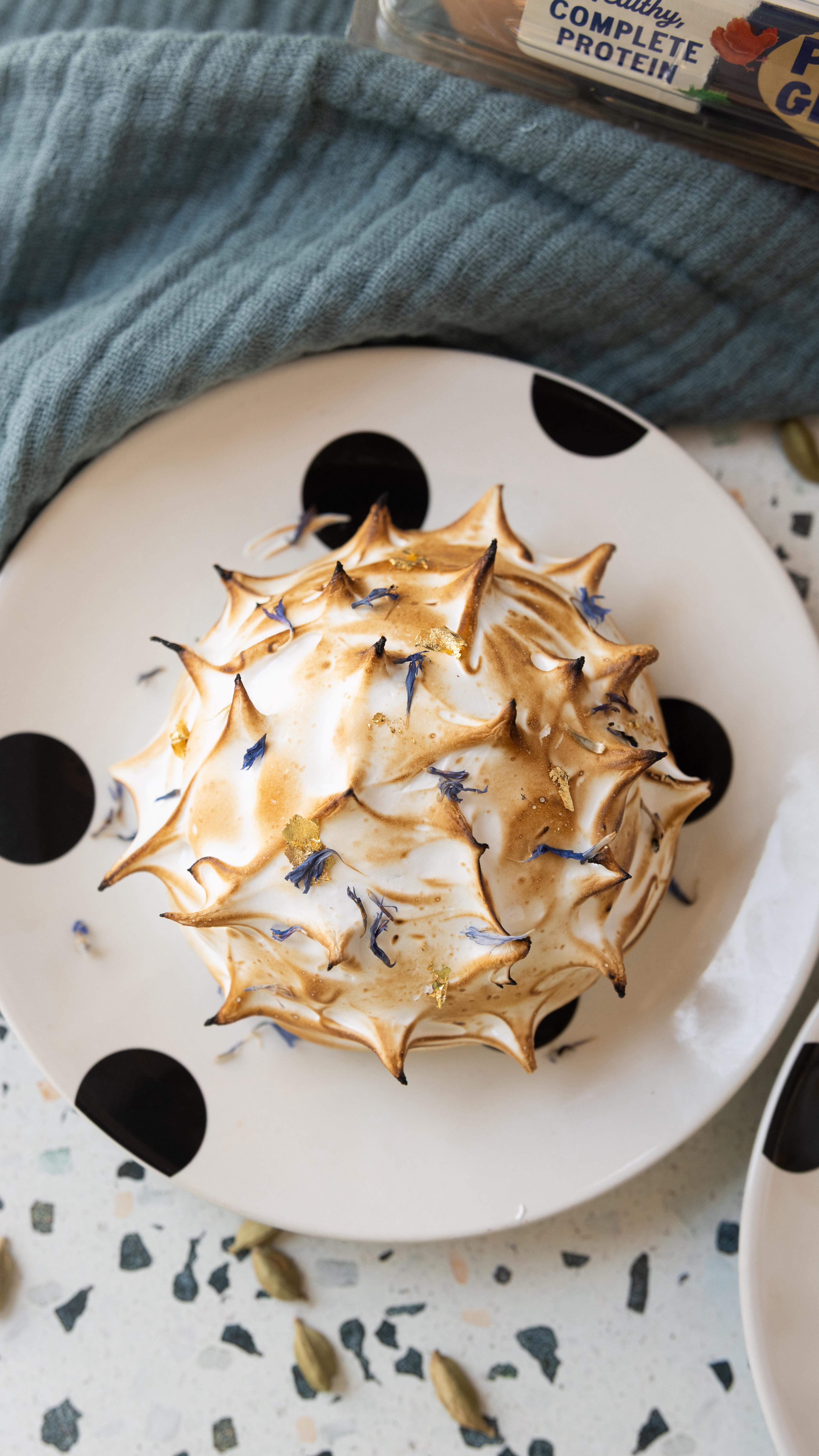 Instagram post by @milkandcardamom for Pete & Gerry's. Caption reads: #ad This is my cardamom semifreddo Baked Alaska!....