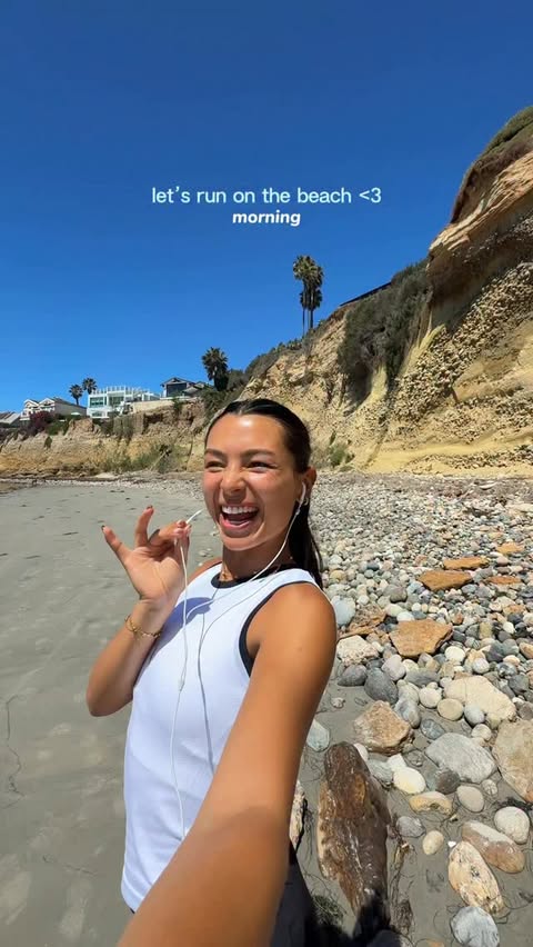 Instagram post by @happywithmeg for Athleta. Caption reads: [...] sunshine & run on the beach🩵 Wearing....