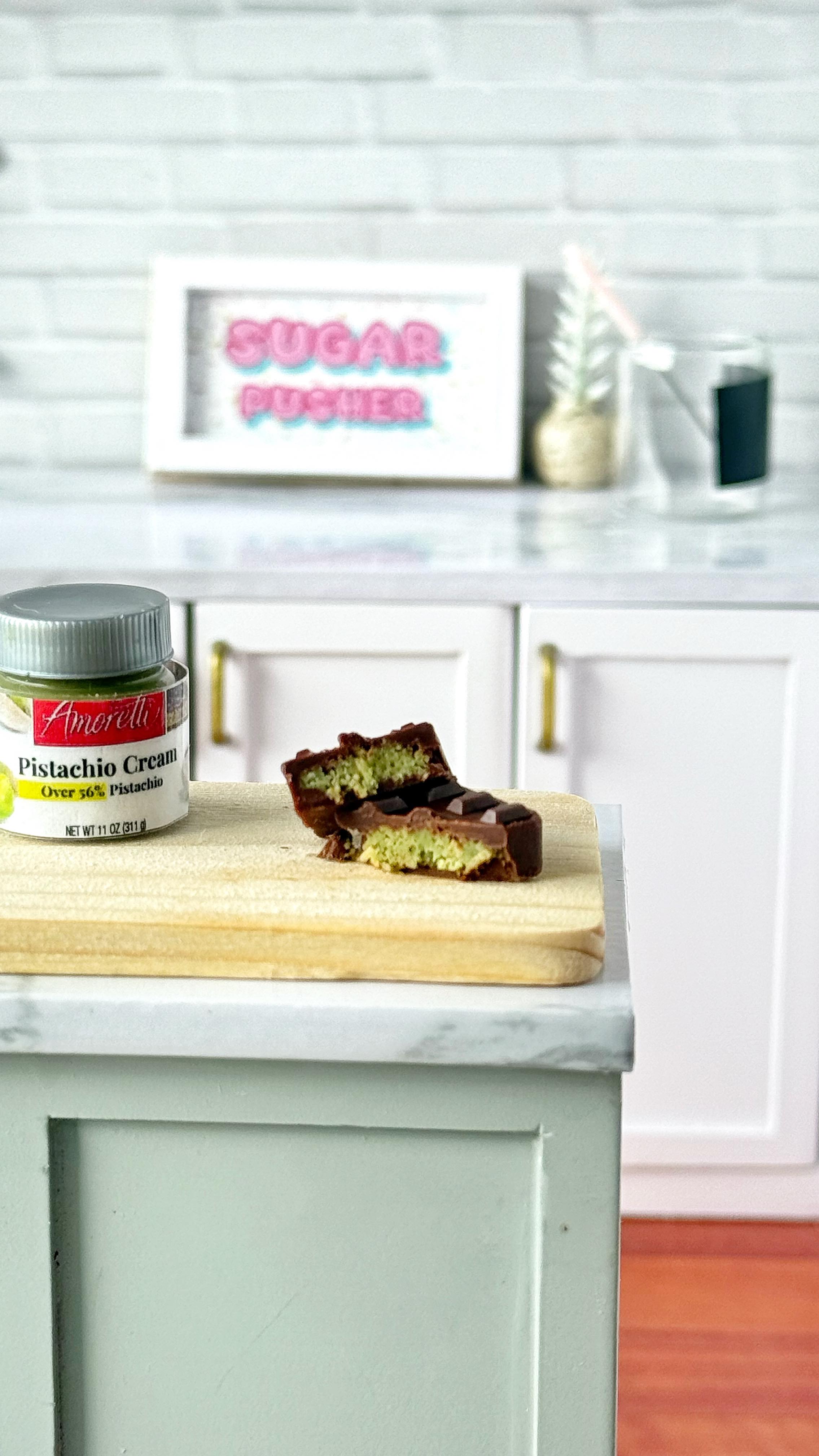 Instagram post by @sugarpusher for Amoretti. Caption reads: Is this the world’s tiniest edible Dubai chocolate....