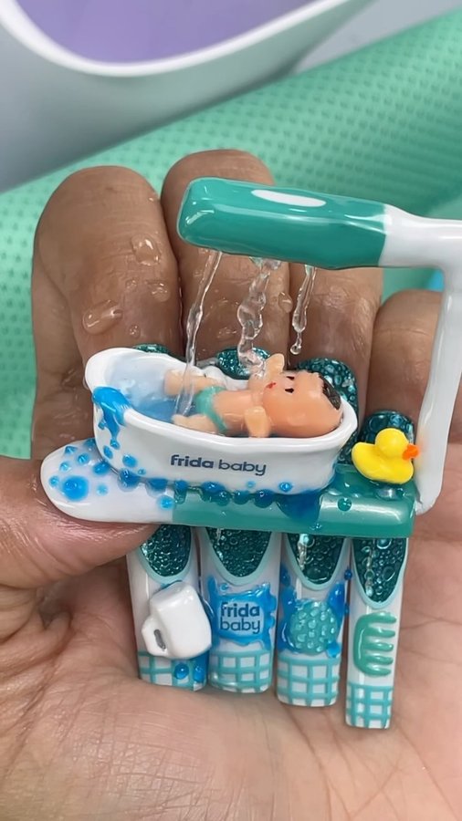 Instagram post by @ilysmnails for Frida Baby. Caption reads: Baby Taking a Relaxing Bath on my NAILS! 👶🚿🛁 So....