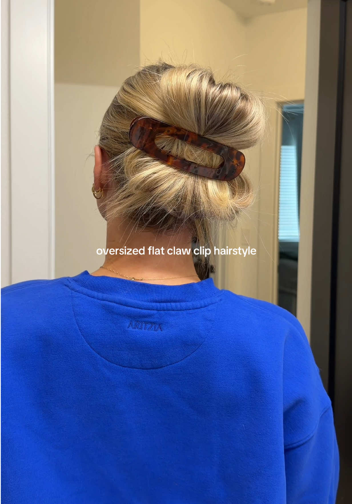 TikTok post by @emilyirlbeck for Kaxi. Caption reads: OBSESSED with this flat claw clip from @KAXI CO....