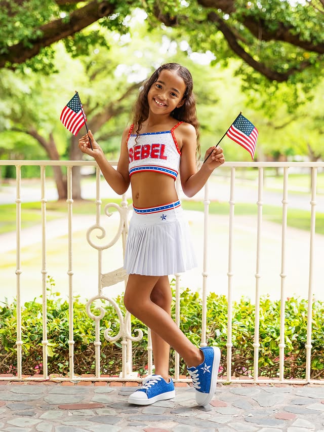 Instagram post by @emmamaria2017 for Rebel Athletic. Caption reads: 💙 Remembering and honoring the heroes who made....