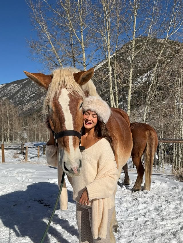 Instagram post by @lauravanessa_w for Moon Boot. Caption reads: winter cuddles🐴🏔️ @revolve @fwrd #revolvewinter....