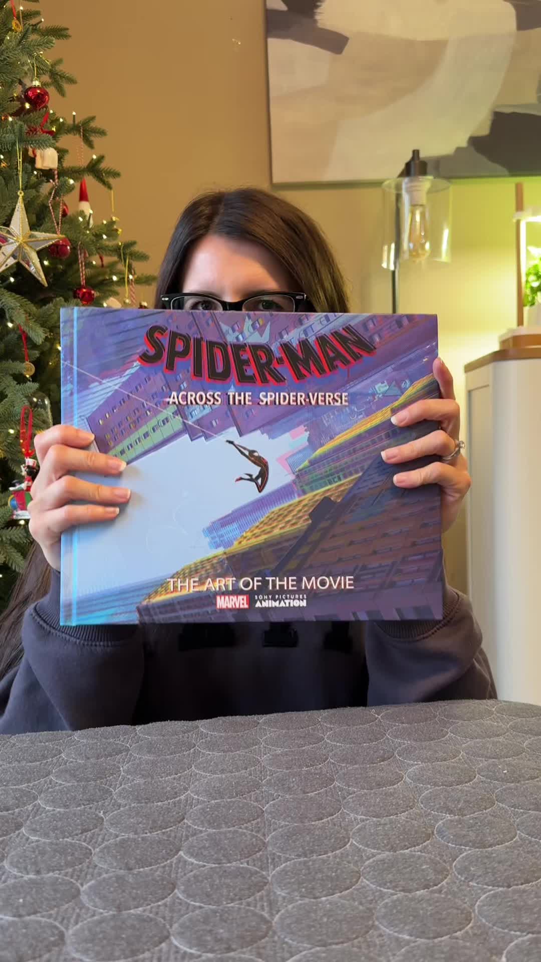 TikTok post by @violet.hollow for Books2Door. Caption reads: [...] spider-verse art of the movie book!....