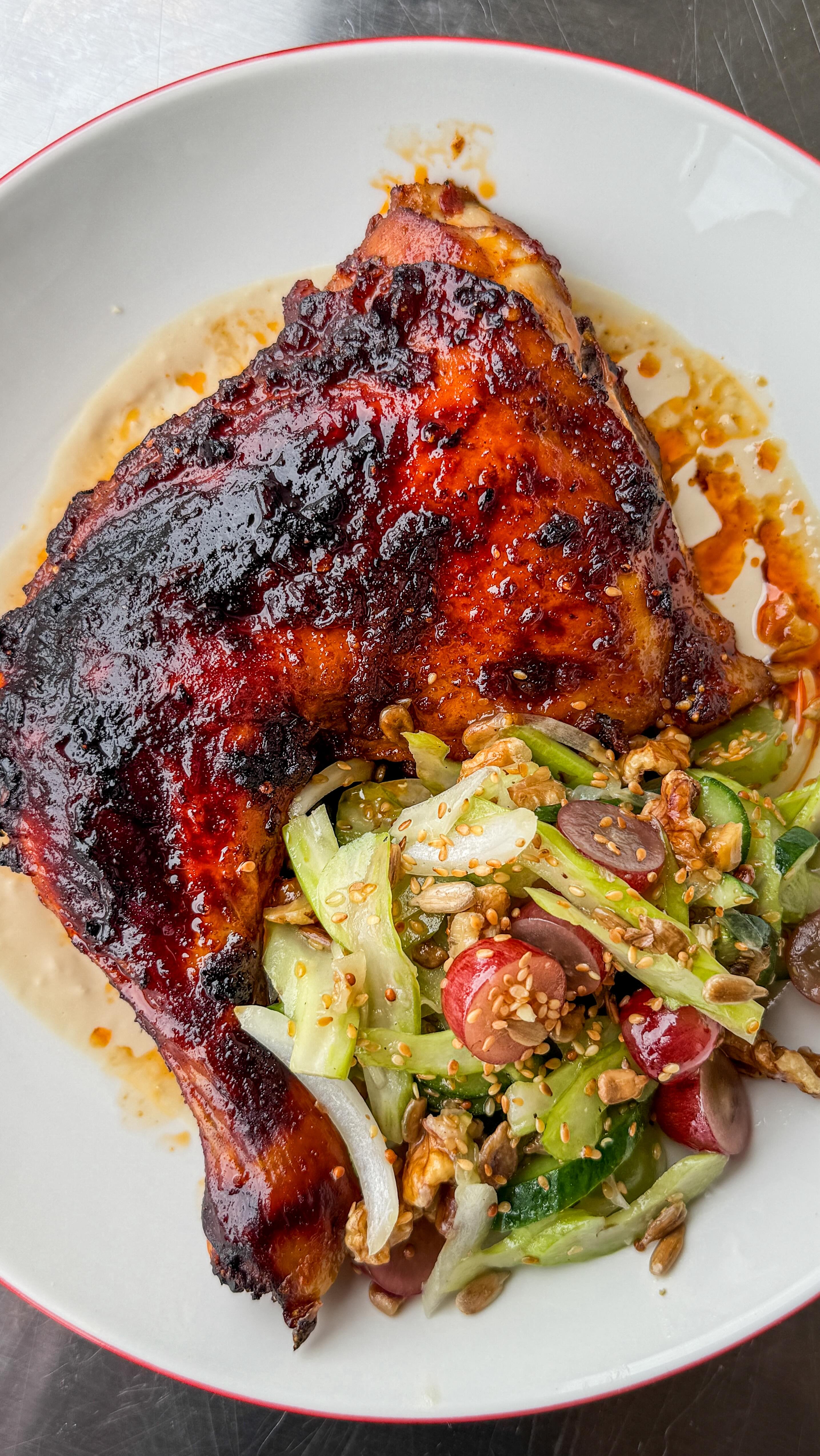 Instagram post by @primal_gourmet for Grapes from California. Caption reads: Harissa Roast Chicken with Crunchy California....