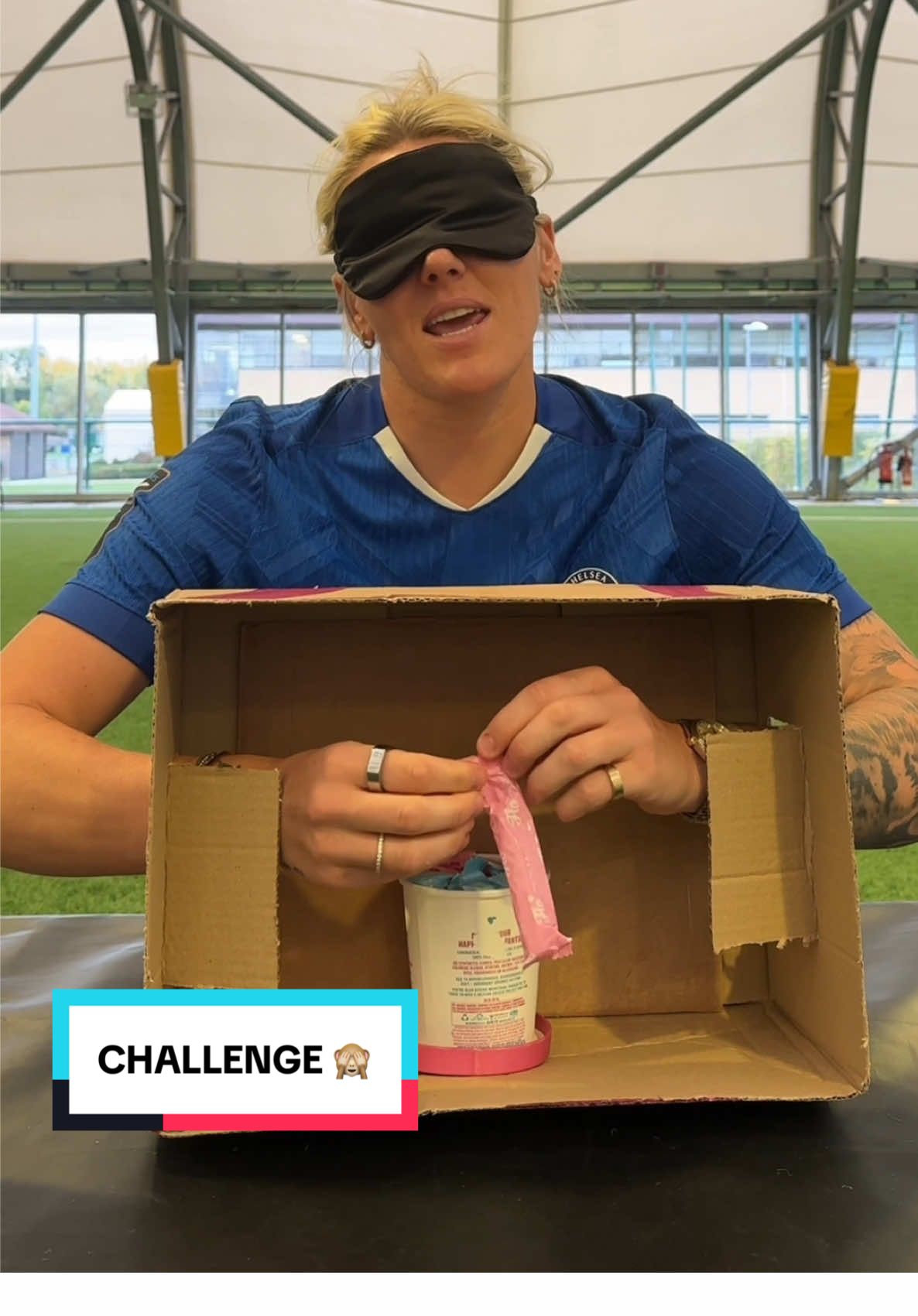 TikTok post by @chelseafcw for Here We Flo. Caption reads: Millie Bright takes on the @Here We Flo Blindfold....