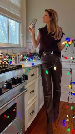 Instagram post by @naomie_olindo for Truly Hard Seltzer. Caption reads: No holiday party is complete without my favorite....