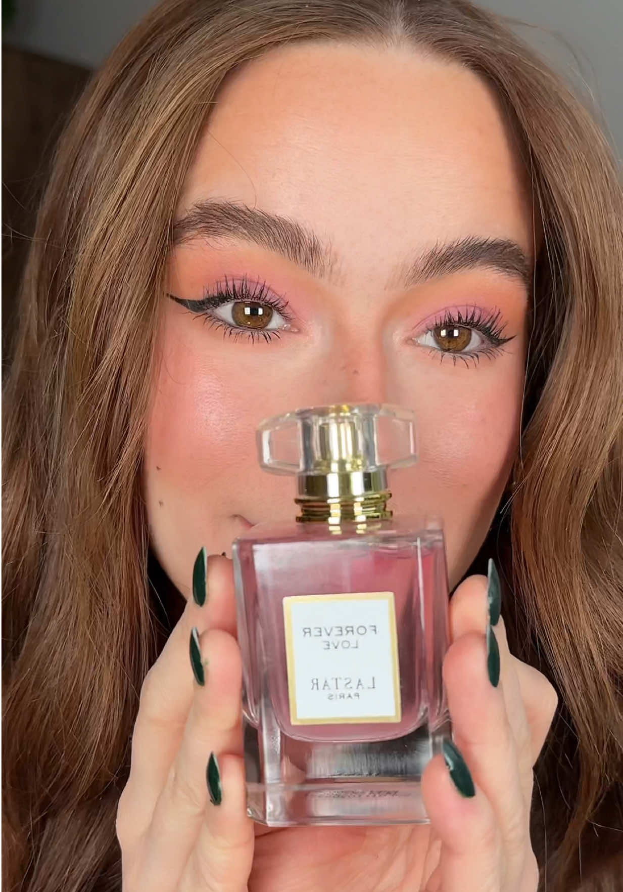 TikTok post by @mmaddierosehill for AliExpress. Caption reads: Try matching your makeup to your perfume because I....