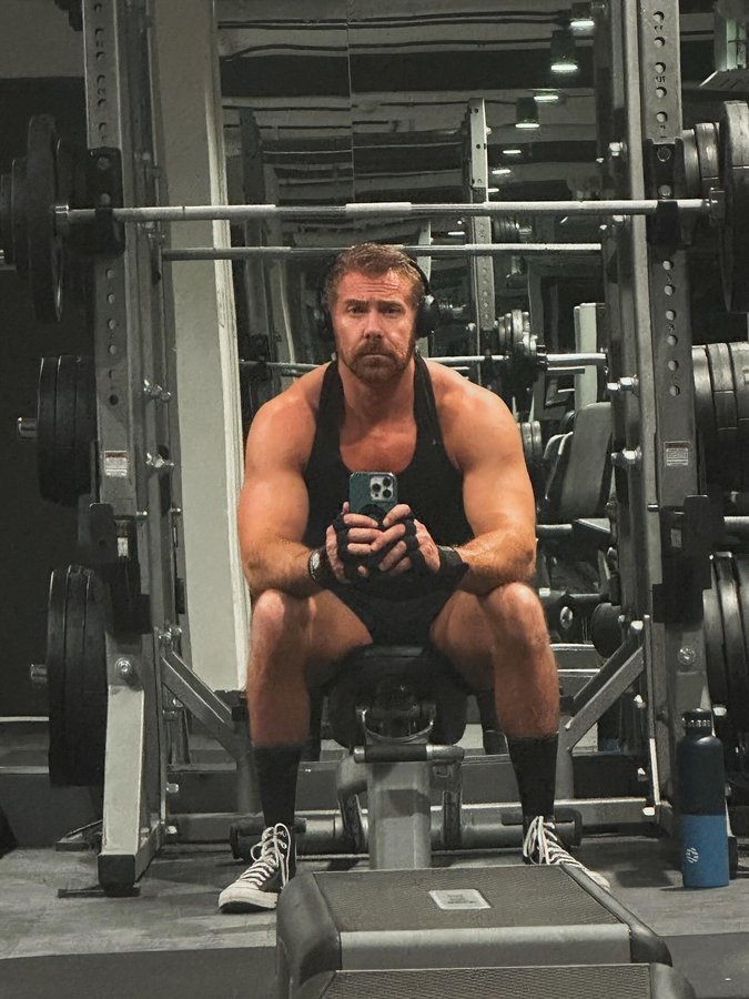 Instagram post by @dustindurham for Planet Fitness. Caption reads: Mean muggin’ from across the gym. (Home gym, not....