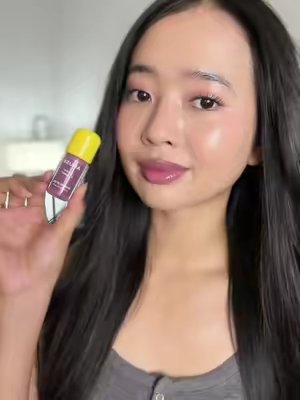 TikTok post by @glowwithsophiaa for AMUSE Seoul. Caption reads: Obsessed with this banana lip oil @AMUSE Seoul 💕✨.