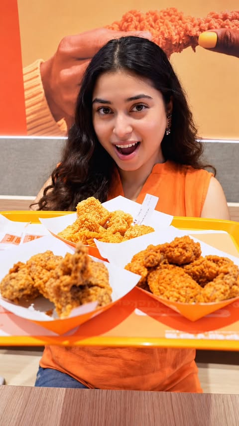 Instagram post by @heyitsnehaverse for Popeyes. Caption reads: [...] Bangalore has some exciting news! 🍗🔥....