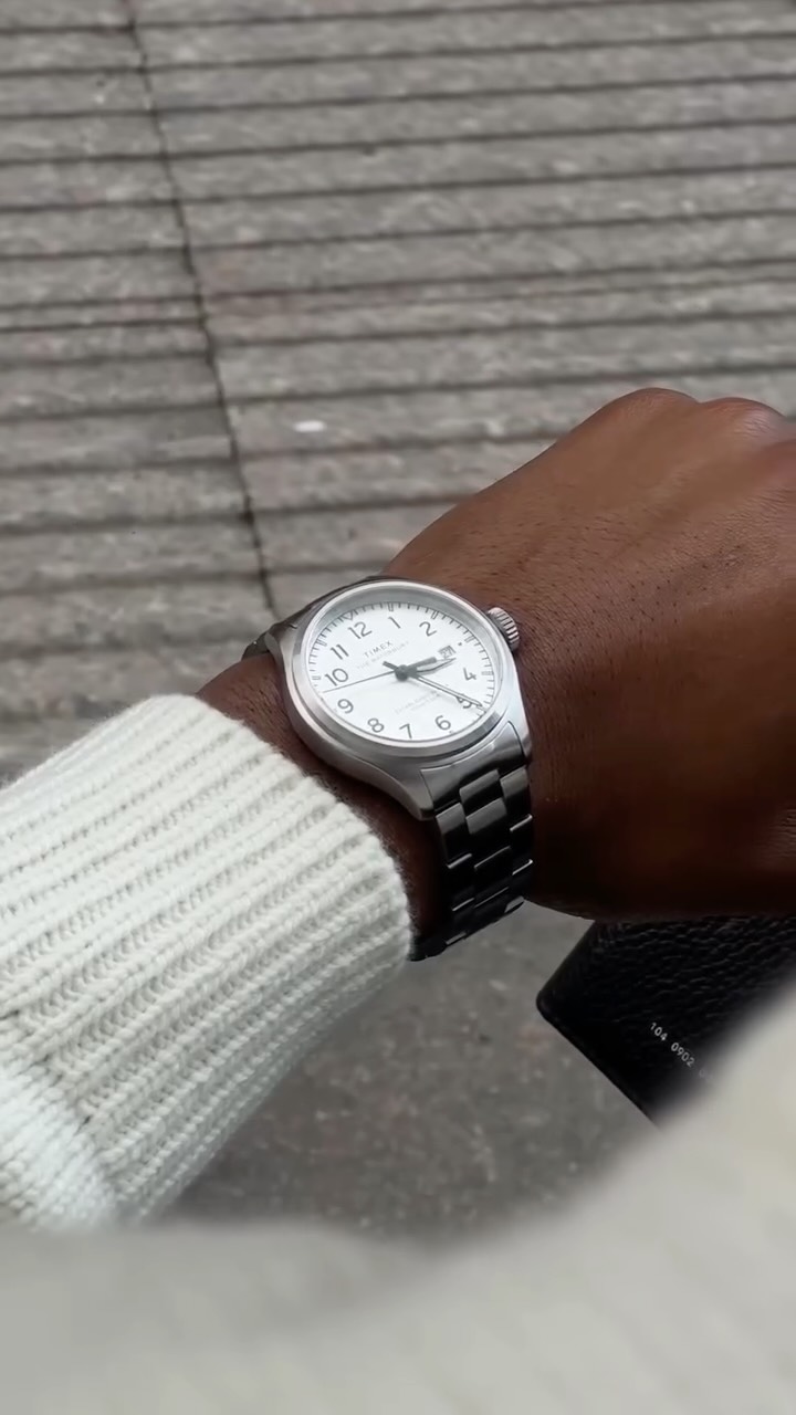 Instagram post by @kunmibalogun for Timex. Caption reads: Minimal Fall Outfit with the @timex Waterbury Ace....