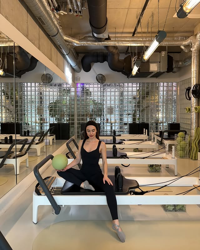 Instagram post by @elmiragadzhyieva for OCEANSAPART. Caption reads: [...] day, new outfit🤍 pilates look from....