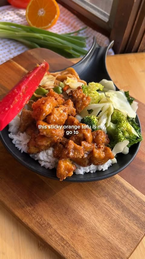 Instagram post by @theveganpigeon for Nasoya. Caption reads: 🍊Sticky Orange Tofu with @nasoya Super Firm Tofu....