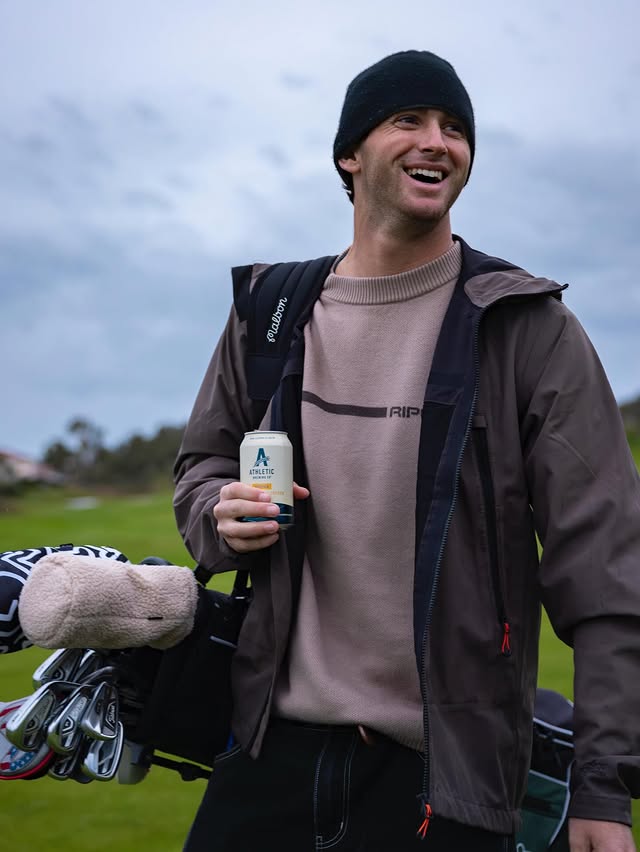 Instagram post by @crosbycola for Athletic Brewing. Caption reads: [...] to get back on the road again ....