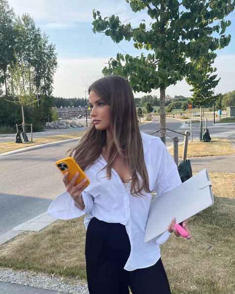 Instagram post by @emmawinterhagen for Holdit. Caption reads: smiling because of @holditbrand colors🧡.