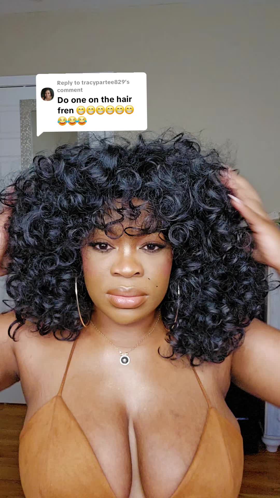TikTok post by @brittbratstyles for Asteria Hair. Caption reads: Replying to @tracypartee829 #wig #curlyhair....