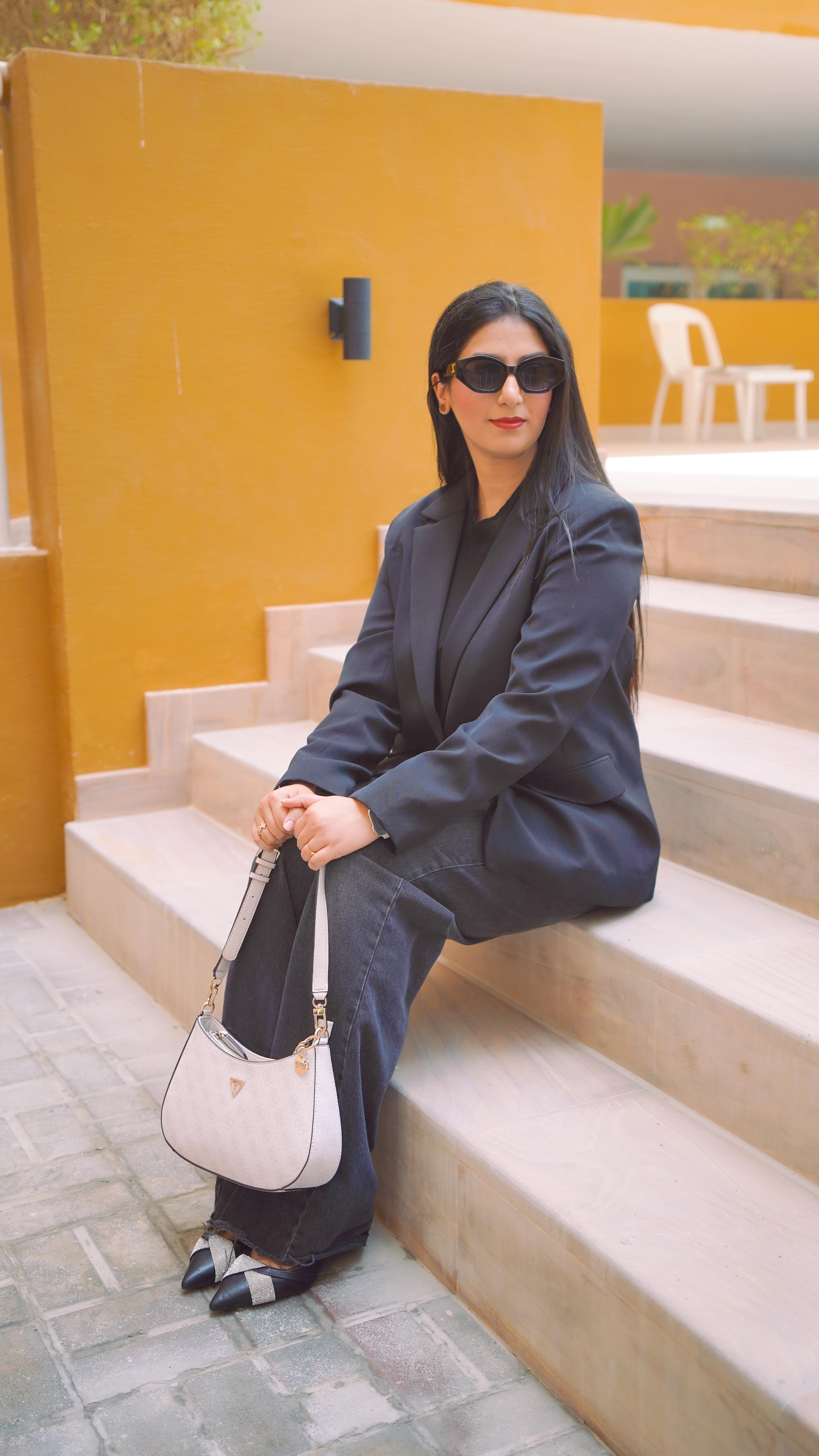 Instagram post by @thetrendylittlethings for Namshi. Caption reads: One GUESS bag, three moods. 💼✨ Namshi X GUESS....