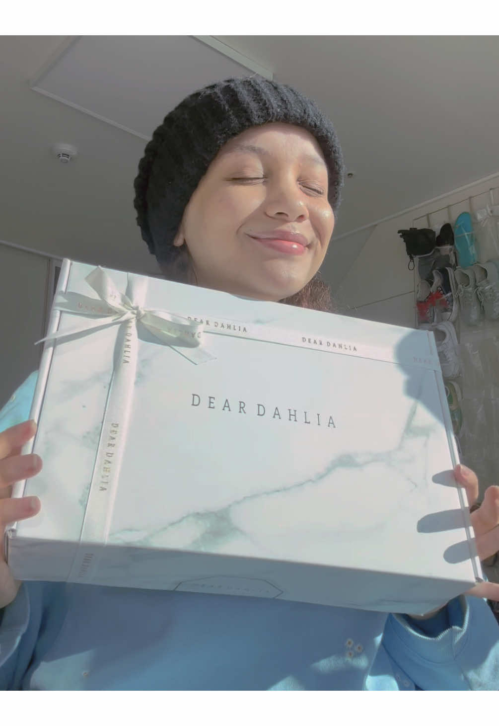 TikTok post by @n_v.ee for DearDahlia. Caption reads: Unboxing the prettiest delivery from @Dear Dahlia....
