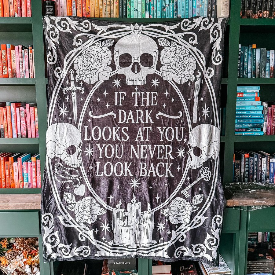 Instagram post by @buildingourbookshelves for Fae Crate. Caption reads: [...] I’m loving this cozy blanket from the....