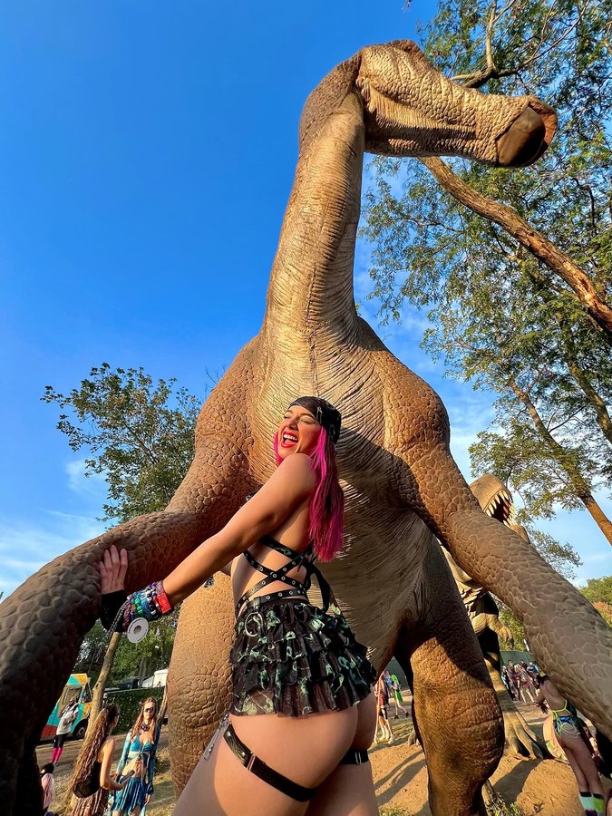Instagram post by @pinkravebunny for iHeartRaves. Caption reads: Dinoland🦕🦖
.
What a day! I had so much fun with....