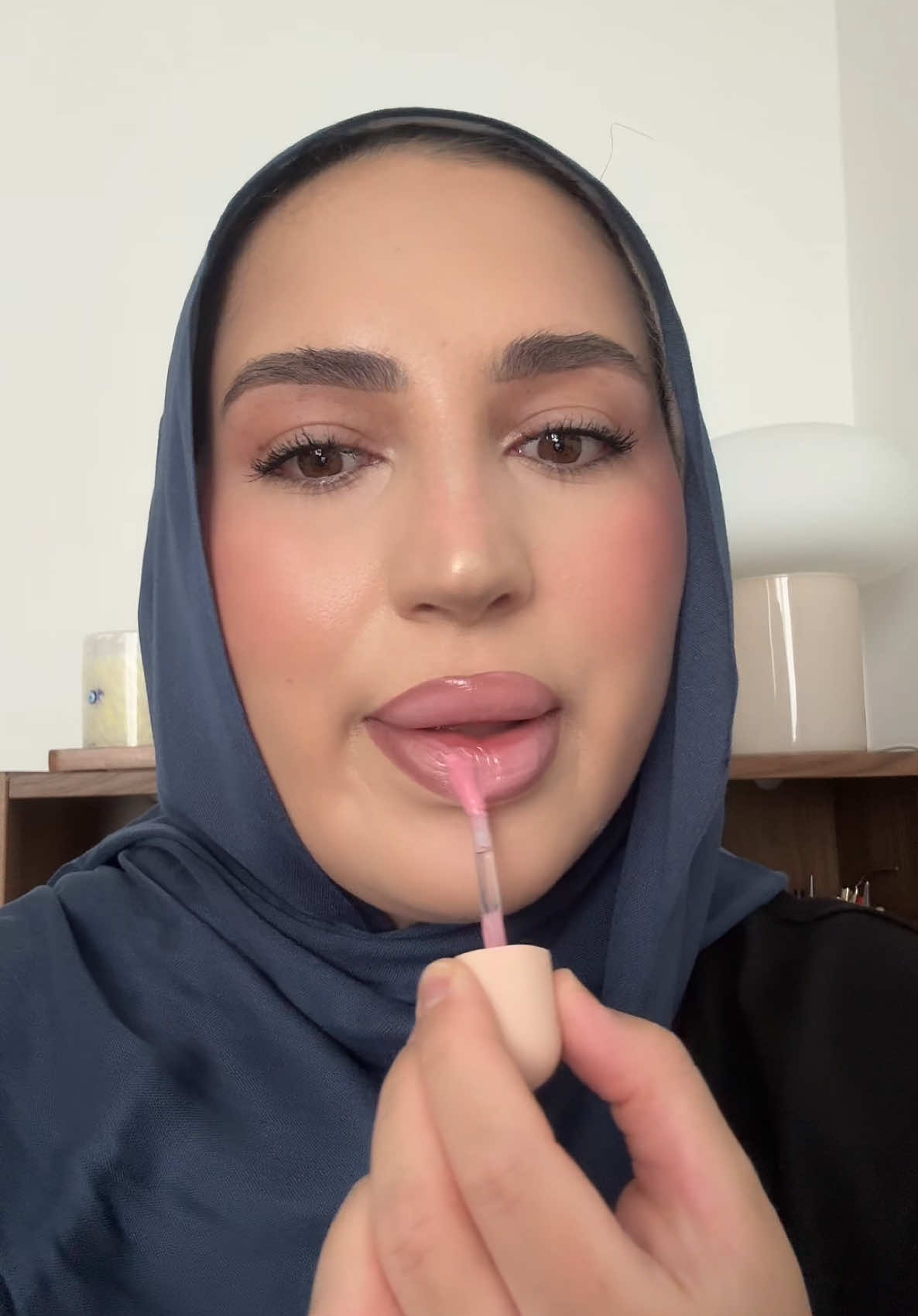 TikTok post by @fatimachabila for HNB Cosmetics. Caption reads: light pink gloss is just elite @HNB Cosmetics -....