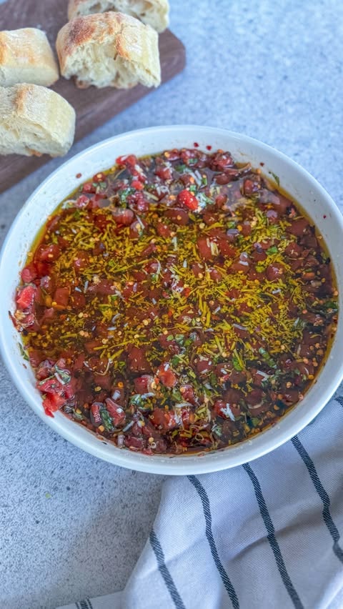 Instagram post by @makefoodlovely for The Feedfeed. Caption reads: (ad) This Bruschetta Bread Dipping Oil with Petite....