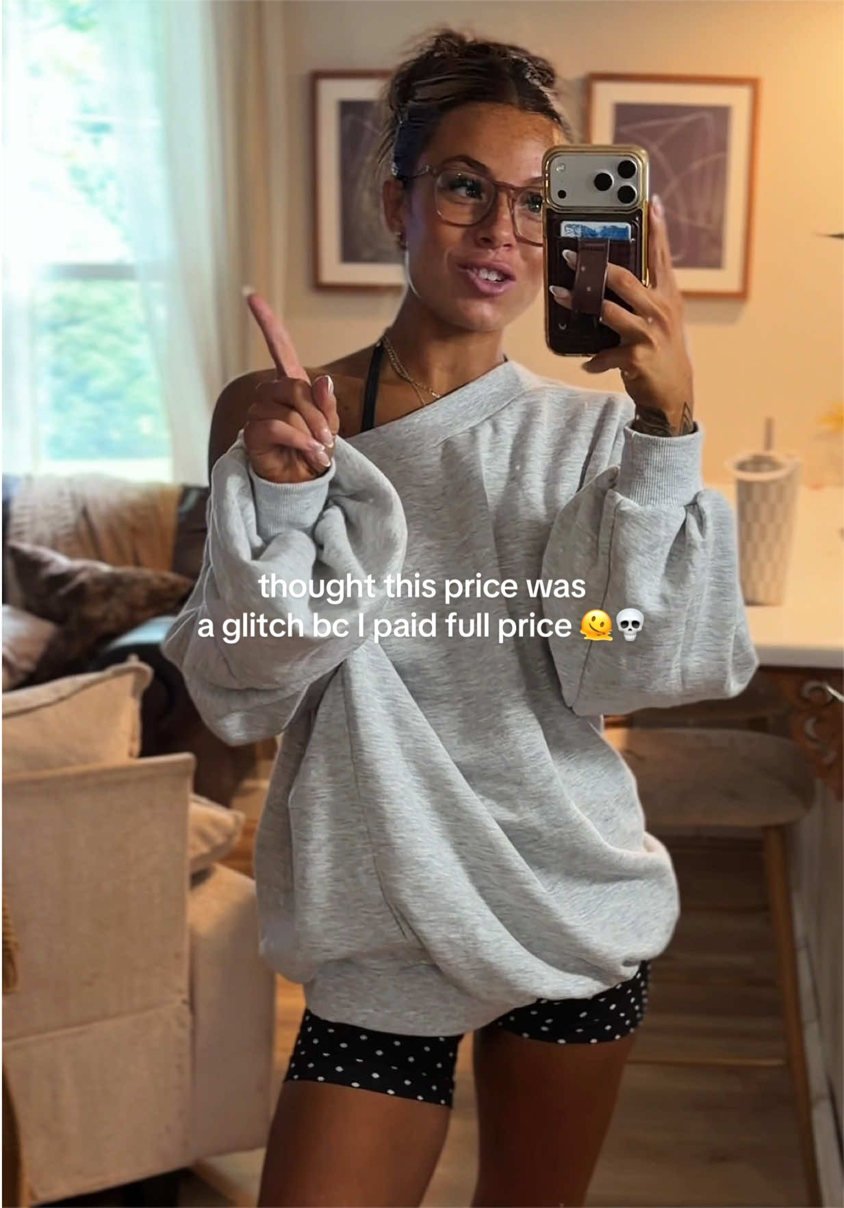 TikTok post by an influencer for Fashion Nova. Caption reads: [...] worn sweatshirt atm 🤪🫣 @Fashion Nova....
