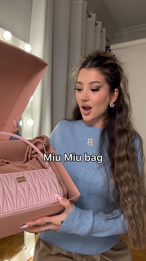 Instagram post by @venetiakamara for Miu Miu. Caption reads: Unboxing: Miu Miu matelasse nappa pink pouch bag....
