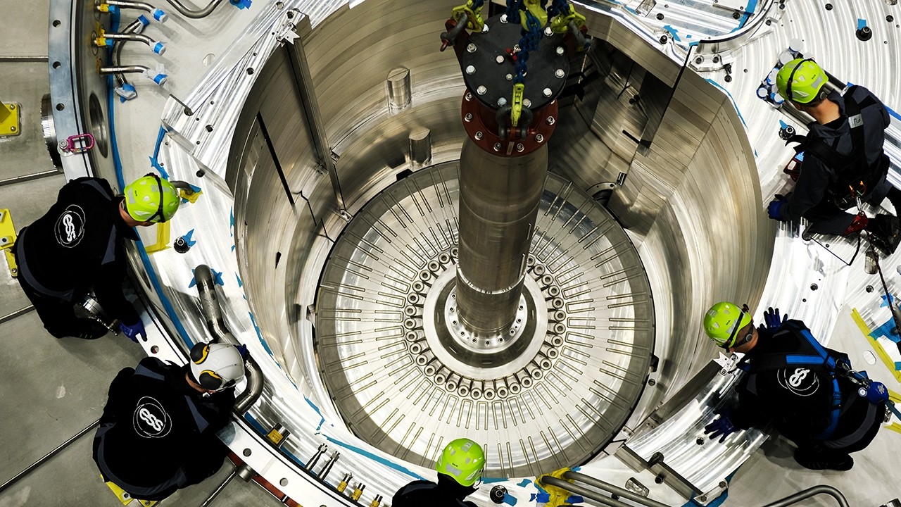 YouTube post by @TheB1M for Brilliant.org. Caption reads: Inside The $3BN Mega-Lab That Will Change The....