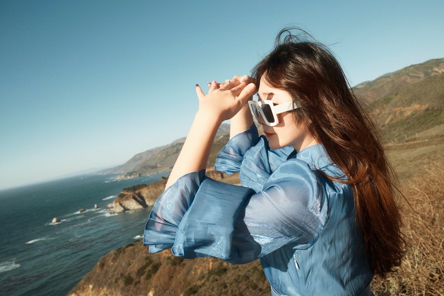 Instagram post by @joecyzhang for SOJOS VISION. Caption reads: 🌊Ocean eyes, Big Sur sighs — blue dress stealing....