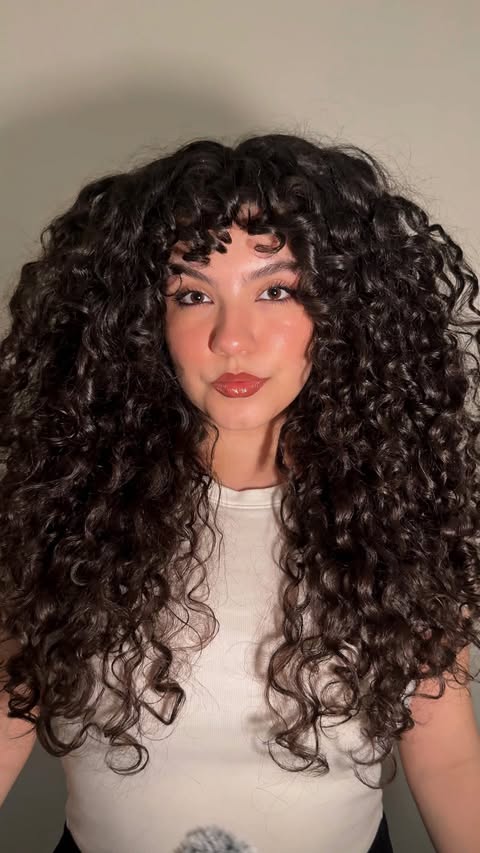 Instagram post by @13rianda for John Frieda US. Caption reads: PSA to all my curlies: the new @johnfriedaus....