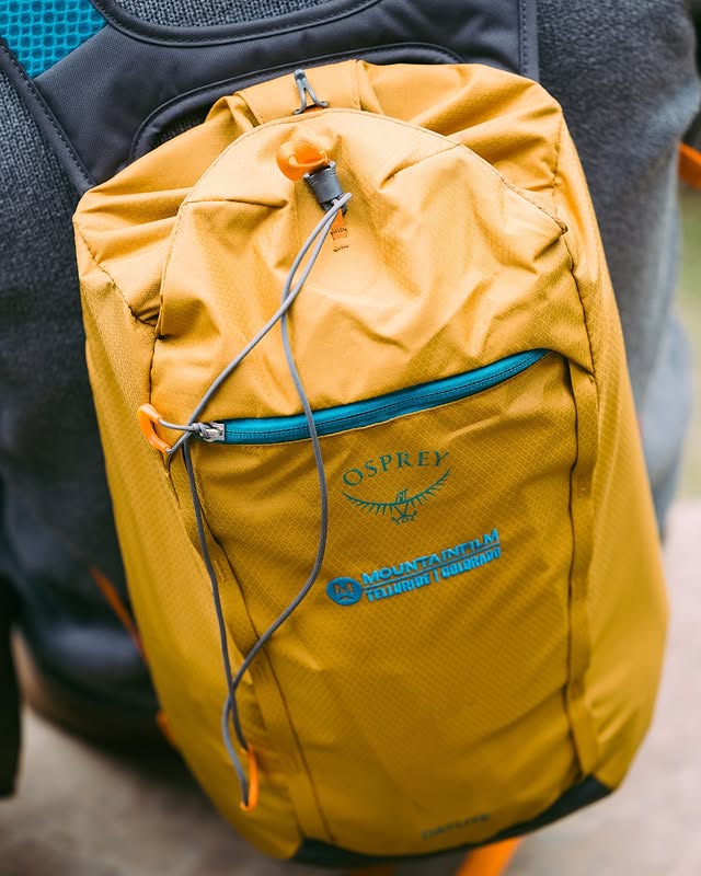 Instagram post by @mountainfilm for Osprey Packs. Caption reads: [...] a better world. See you in Telluride.....
