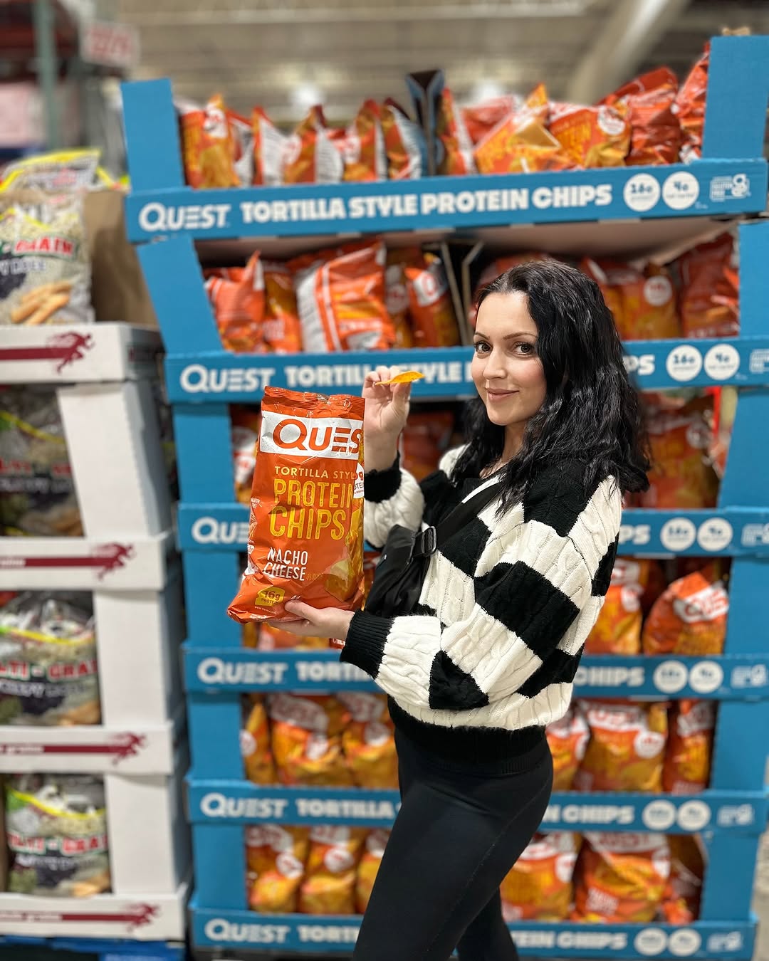 Instagram post by @amothertwosons for Quest Nutrition. Caption reads: We discovered an amazing snack at Costco today! 🎉....