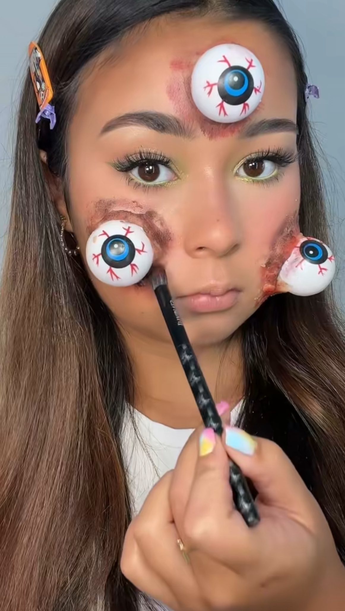 Instagram post by @rubyleighmakeupp for HNB Cosmetics. Caption reads: i’ve got my eyes on you 👀💚 🔪🩸 a little bit of....