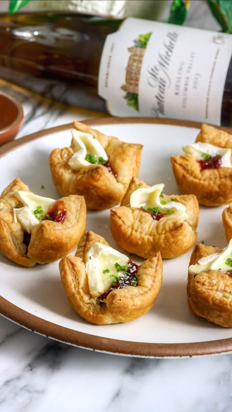 Instagram post by @foodmymuse for Chateau Ste. Michelle Winery. Caption reads: #ad Spicy Cranberry Brie Bites +....