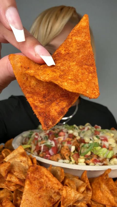 Instagram post by @cookitgirleats for Chipotle. Caption reads: Behind the line at @chipotle 👀🌶️ The all new....
