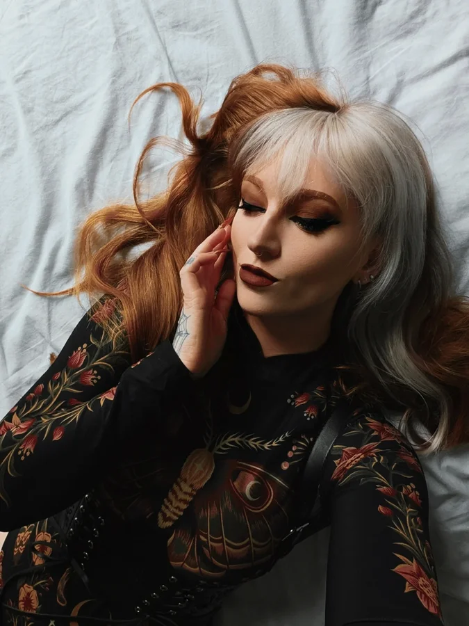 Instagram post by @kllsym for Restyle.pl. Caption reads: [...] point 🦋🧡 bodysuit and harness by....