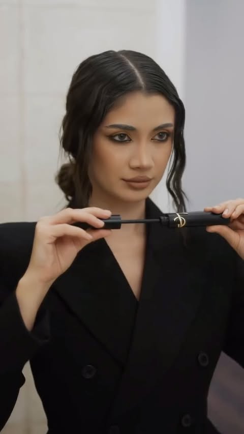 Instagram post by @laurentiabruma for DOUGLAS. Caption reads: [...] #yslmakeup #yslfragrance #paidproject....