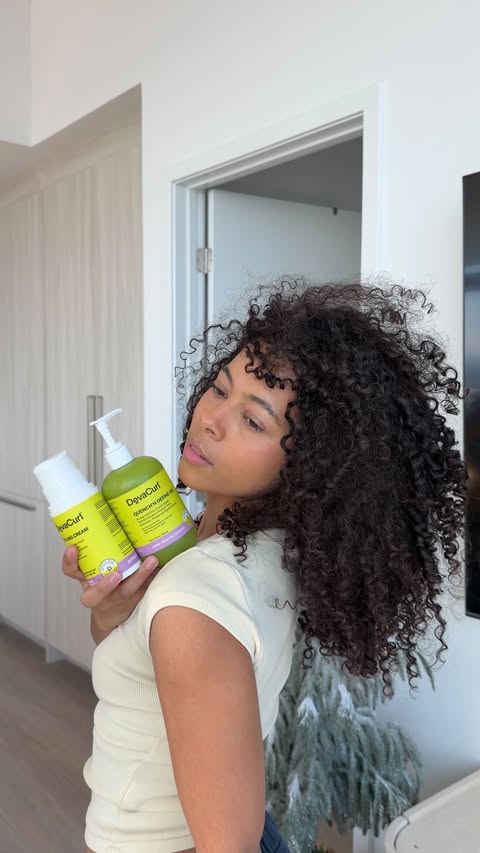 Instagram post by @keyatta.davis for DevaCurl. Caption reads: my easy curly hair routine using @devacurl is....