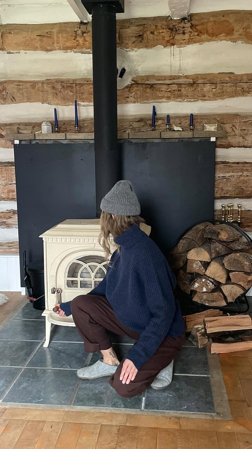 Instagram post by @homebody_ for Finisterre. Caption reads: Gathering firewood with @finisterre.