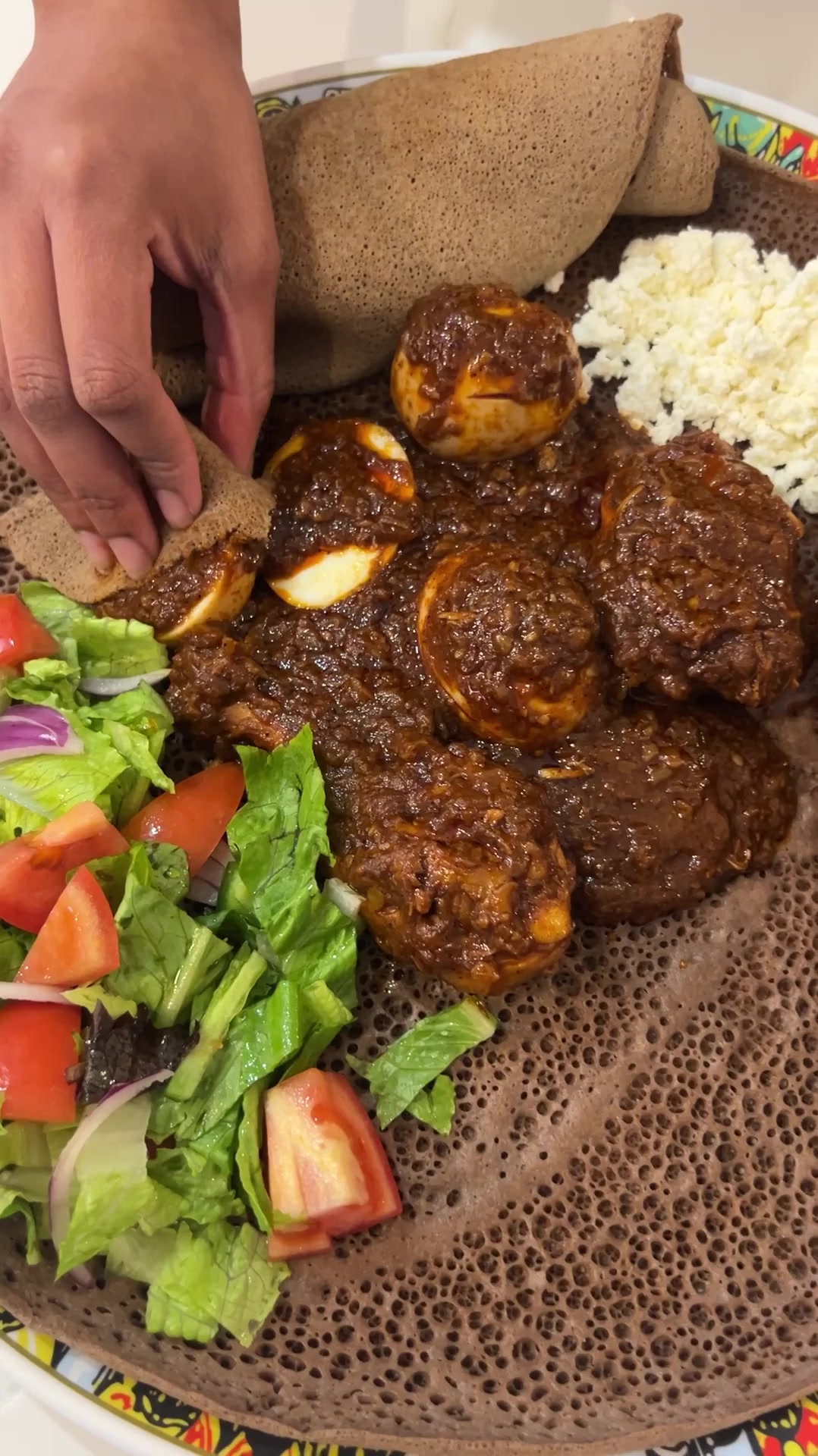 TikTok post by @edenthefoodie for Get Cracking. Caption reads: Doro Wat is one of the most delicious stews you’ll....