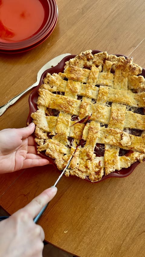 Instagram post by @innkeepercaroline for Travel Wisconsin. Caption reads: This Cherry Cheddar Pie is delicious and features....