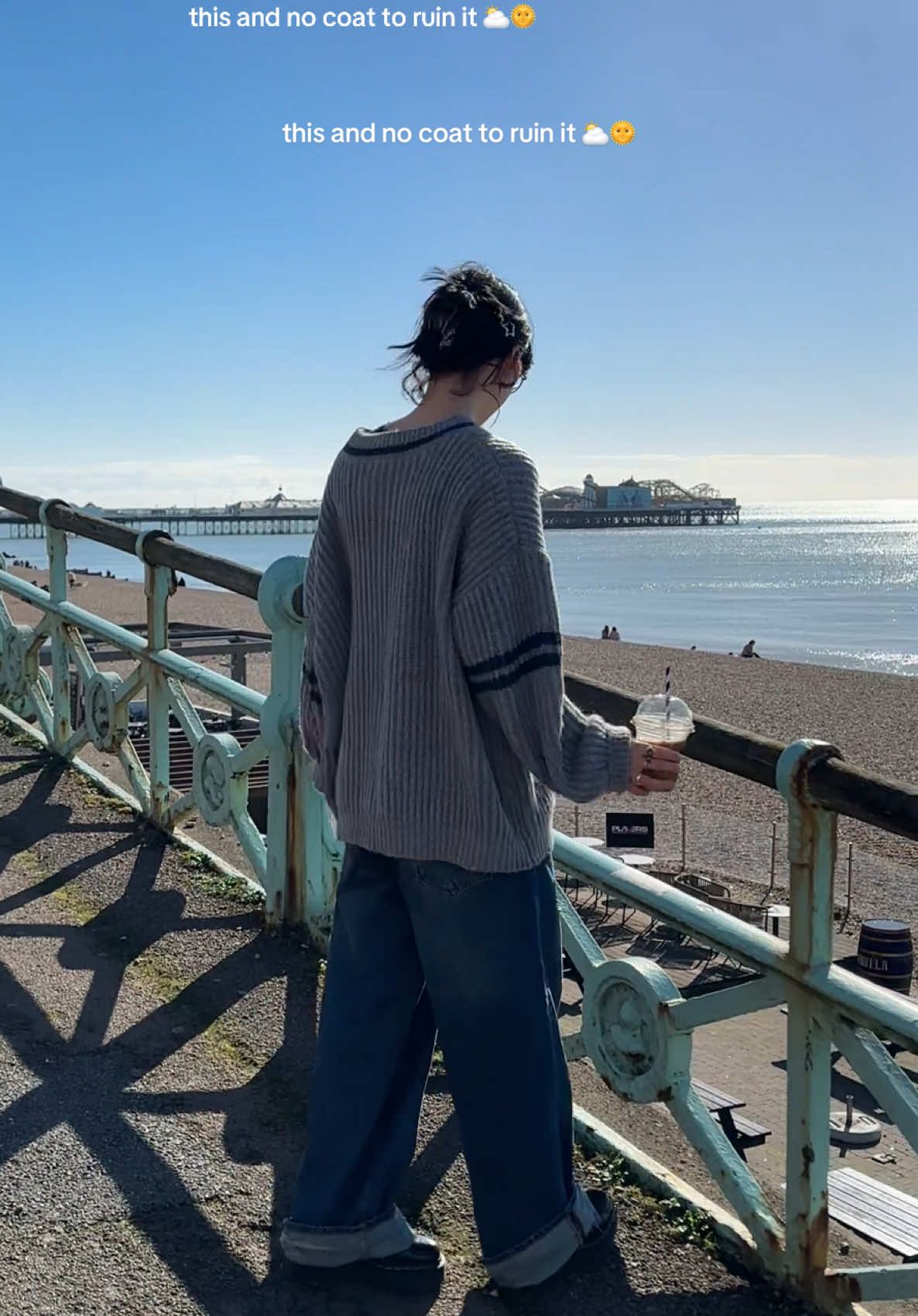 TikTok post by @caitsbookstacks for MOTEL. Caption reads: brighton ootd 🫐🌟 this sweater is my new....