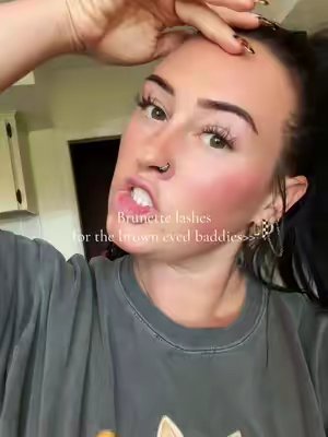 TikTok post by @marissaglesinger7 for FlutterHabit. Caption reads: [...] brown eyed baddie w/ brunette lashes....
