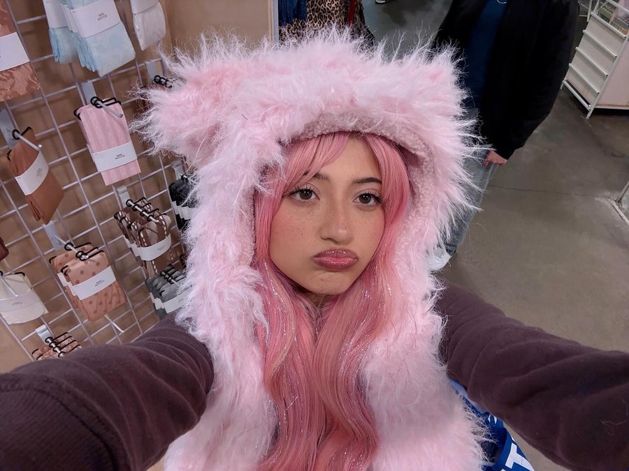 Instagram post by @miravdarae for Urban Outfitters. Caption reads: #selfie in my new hat 😛🧸💕.