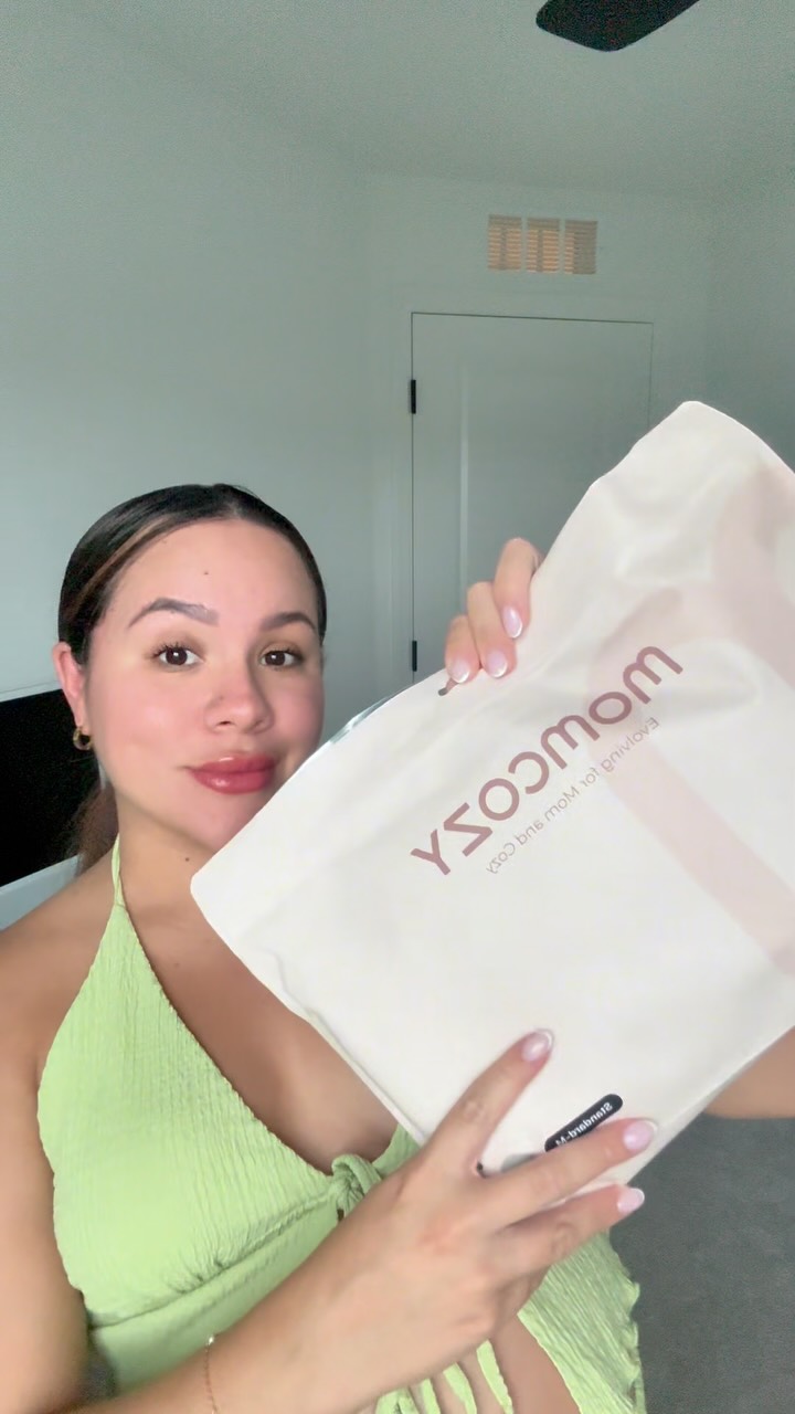 Instagram post by @byjenniferserna for Momcozy. Caption reads: ✨ Postpartum must-haves ✨

Dos productos de....
