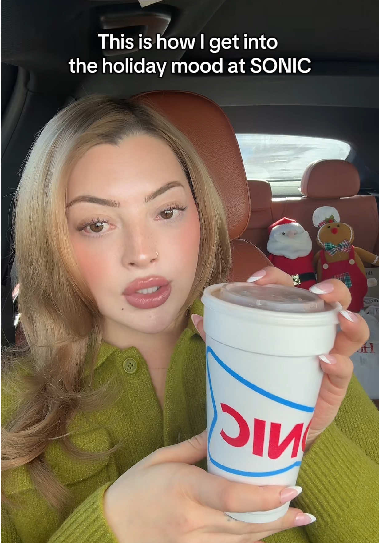 TikTok post by @alexiisbryanna for Sonic Drive-In. Caption reads: The season of giving with @SONIC Drive-In 🎄 🤍....