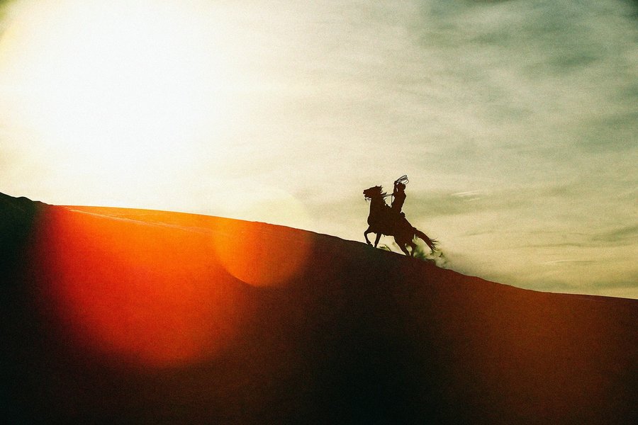 Instagram post by @chrisdouglasphoto for Filson. Caption reads: [...] #cowboy #sunset shot for @filson1897.